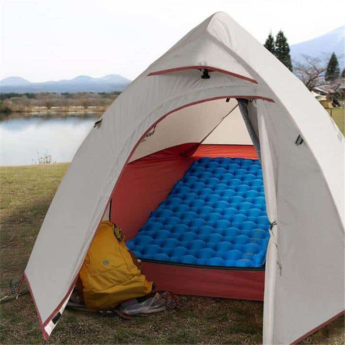 Blue Naturehike ultralight sleeping pad inflated inside a Naturehike tent by a lake
