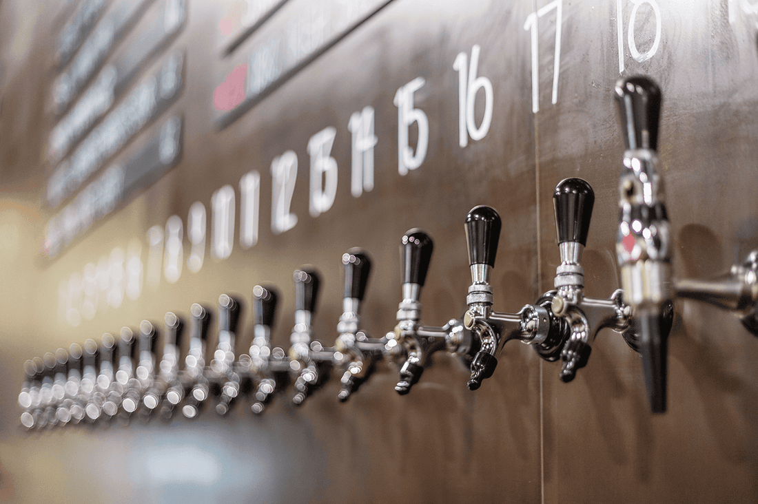 Close-up of Torchlight Brewing's stainless tap wall with numbered draught taps