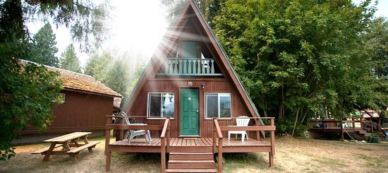 Cedar A-frame chalet cabin with a front deck and picnic table at Kokanee Chalets