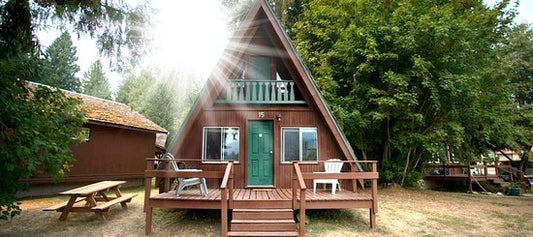 Cedar A-frame chalet cabin with a front deck and picnic table at Kokanee Chalets