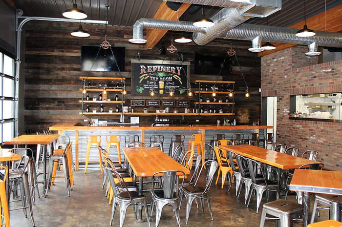Trail Beer Refinery taproom interior with reclaimed wood walls and metal bar stools